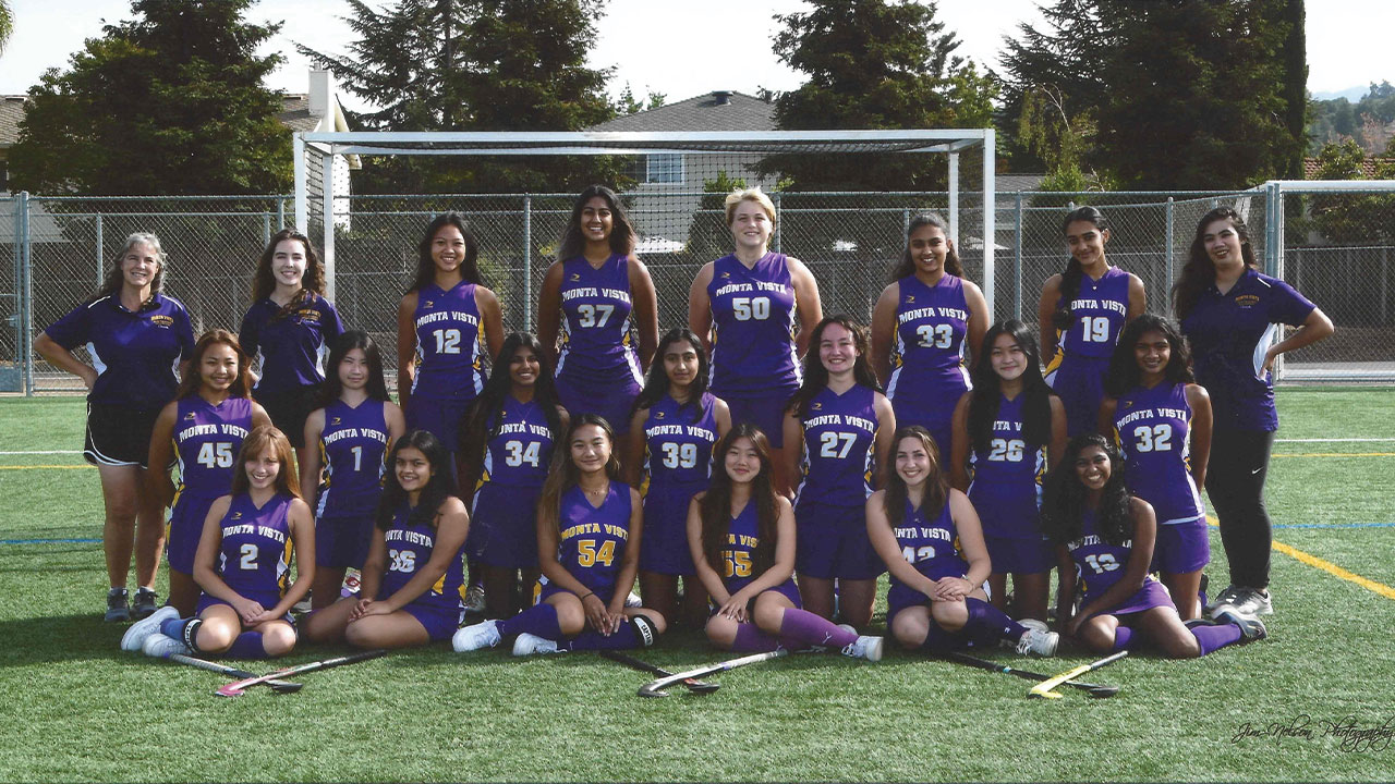Monte Vista Field Hockey Team posing in purple uniforms.