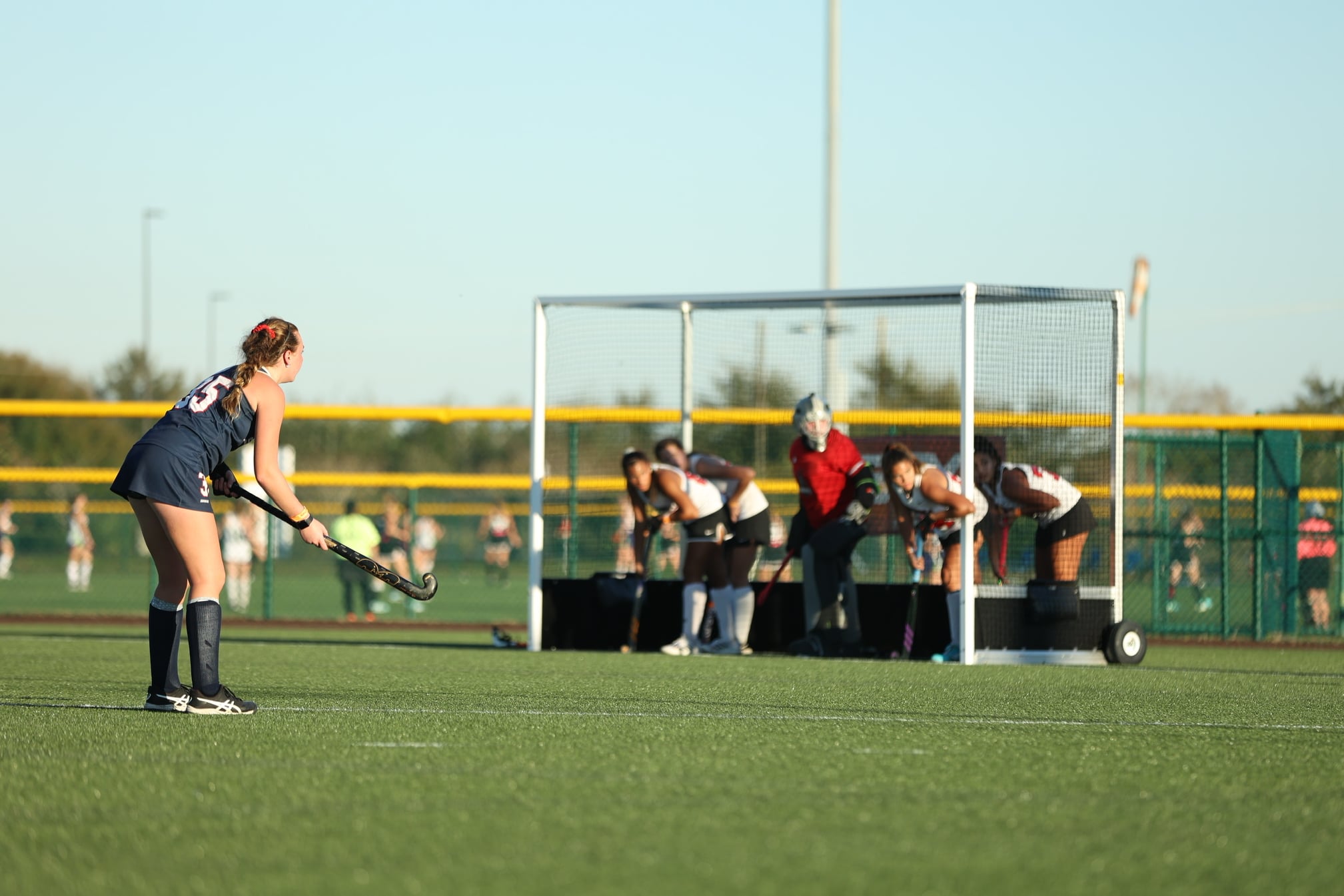 Field hockey players prepare to play out a penalty corner.
