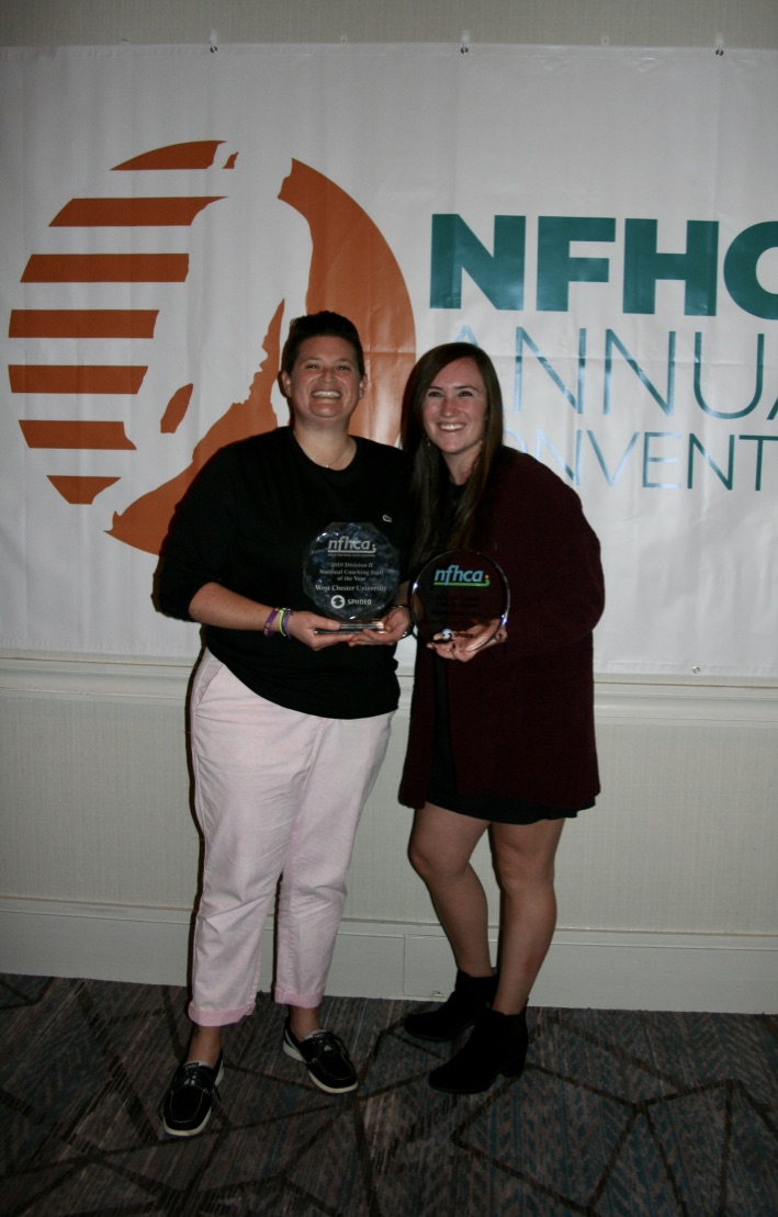 two women holding nfhca trophies
