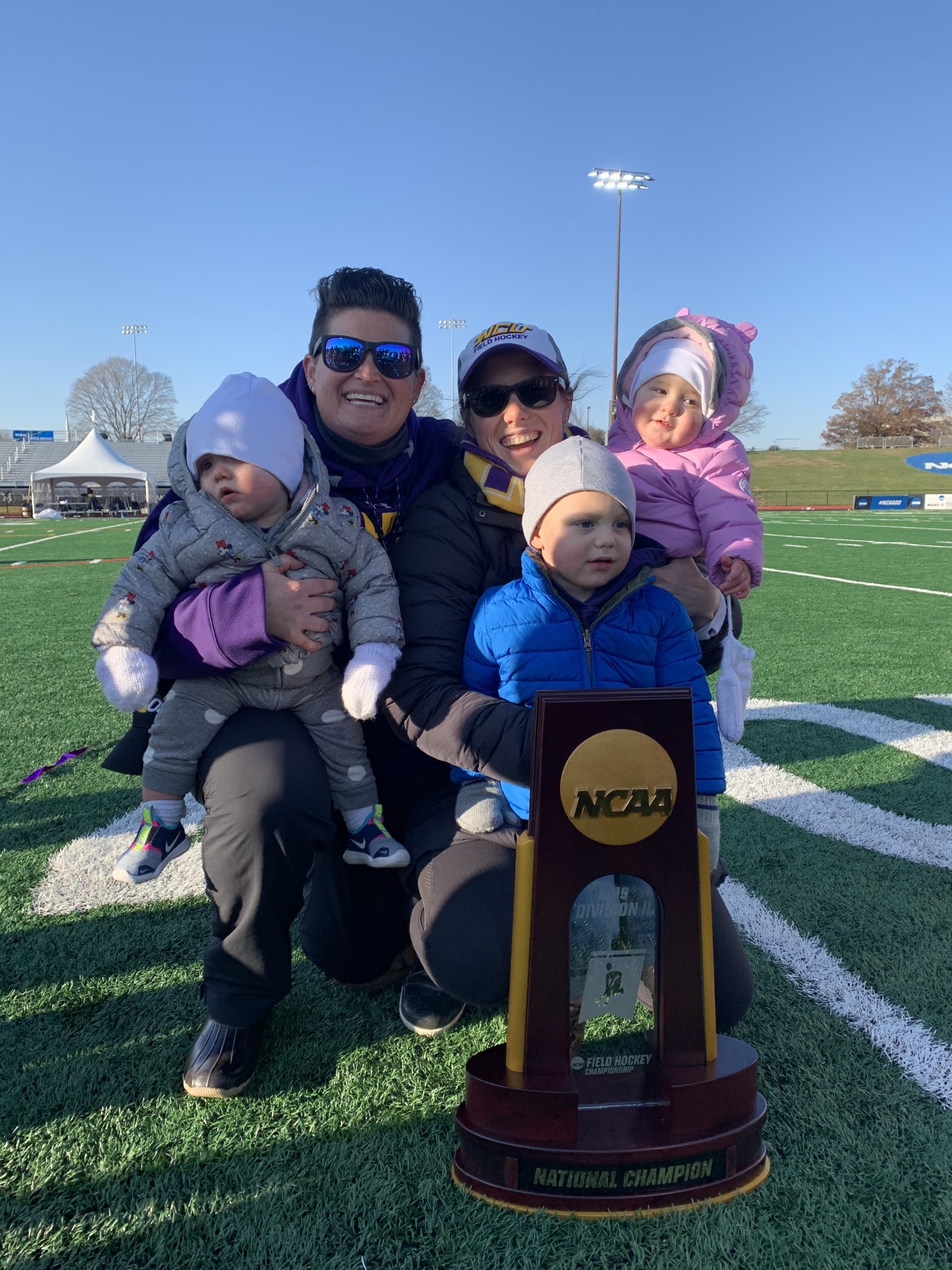 amy cohen with family holding an ncaa trophy